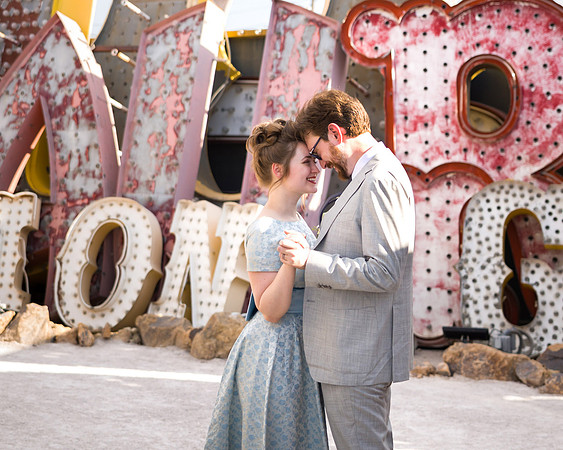 Couple photographed among vintage neon signs at the Neon Museum in Las Vegas