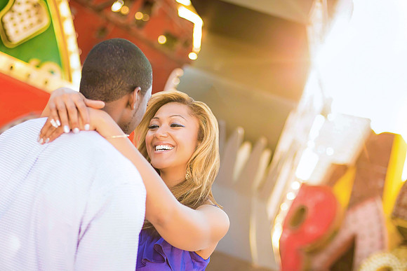 Couple photographed among vintage neon signs at the Neon Museum in Las Vegas