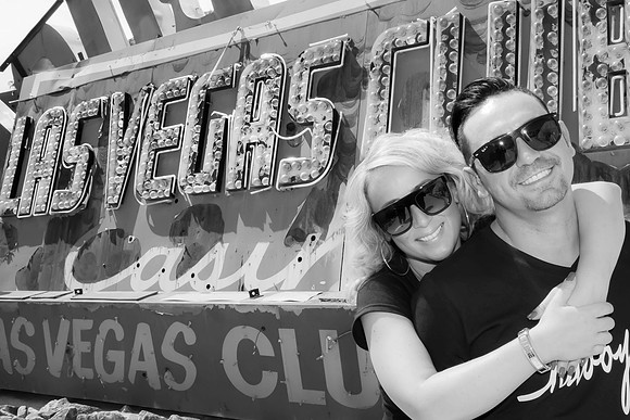 Couple photographed among vintage neon signs at the Neon Museum in Las Vegas