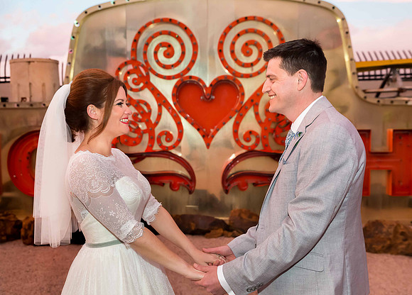 Couple photographed among vintage neon signs at the Neon Museum in Las Vegas