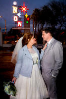 Couple photographed among vintage neon signs at the Neon Museum in Las Vegas