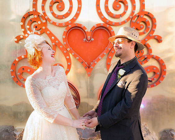 Couple photographed among vintage neon signs at the Neon Museum in Las Vegas