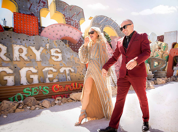 Couple photographed among vintage neon signs at the Neon Museum in Las Vegas