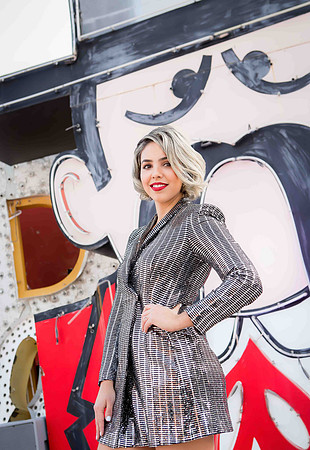 Couple photographed among vintage neon signs at the Neon Museum in Las Vegas