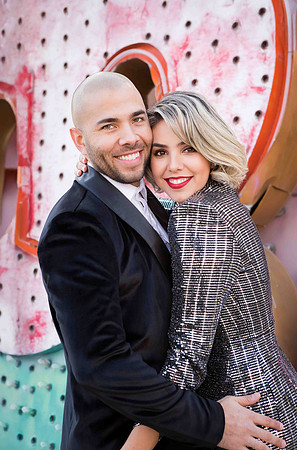 Couple photographed among vintage neon signs at the Neon Museum in Las Vegas