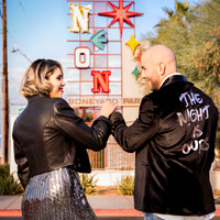Couple photographed among vintage neon signs at the Neon Museum in Las Vegas
