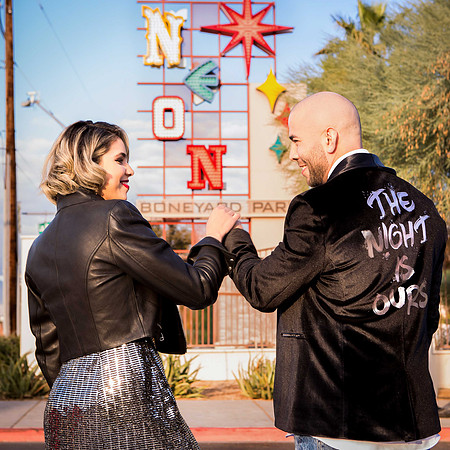 Couple photographed among vintage neon signs at the Neon Museum in Las Vegas