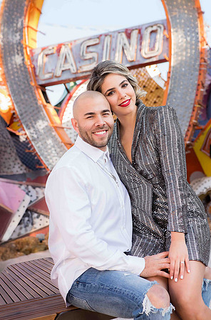Couple photographed among vintage neon signs at the Neon Museum in Las Vegas