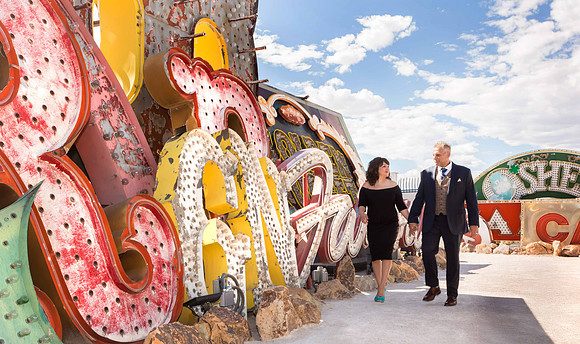 Couple photographed among vintage neon signs at the Neon Museum in Las Vegas