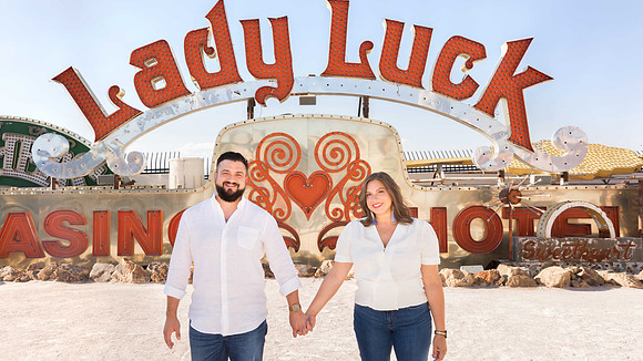Couple photographed among vintage neon signs at the Neon Museum in Las Vegas