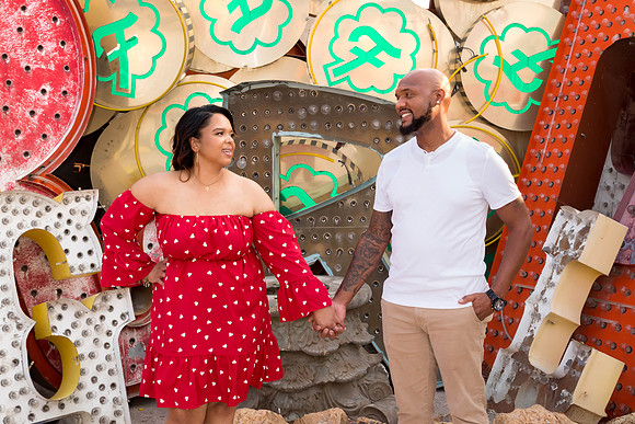 Couple photographed among vintage neon signs at the Neon Museum in Las Vegas