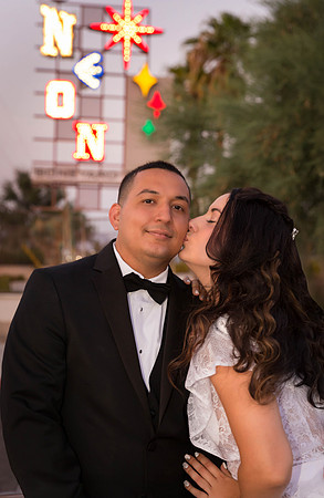 Couple photographed among vintage neon signs at the Neon Museum in Las Vegas