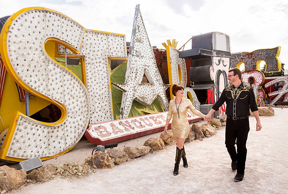 Couple photographed among vintage neon signs at the Neon Museum in Las Vegas
