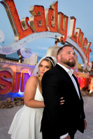 Couple photographed among vintage neon signs at the Neon Museum in Las Vegas
