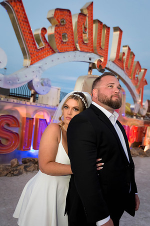 Couple photographed among vintage neon signs at the Neon Museum in Las Vegas
