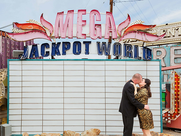 Couple photographed among vintage neon signs at the Neon Museum in Las Vegas