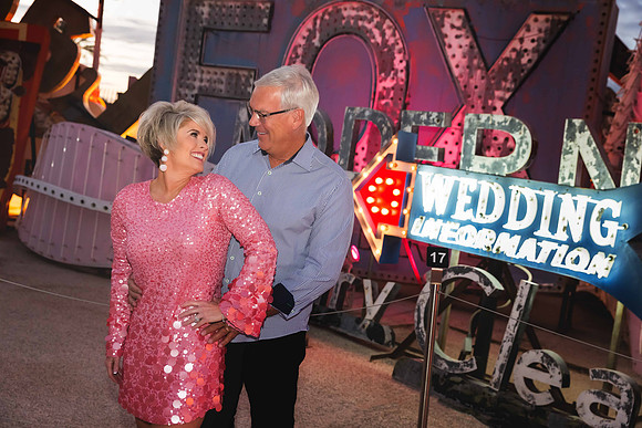 Couple photographed among vintage neon signs at the Neon Museum in Las Vegas