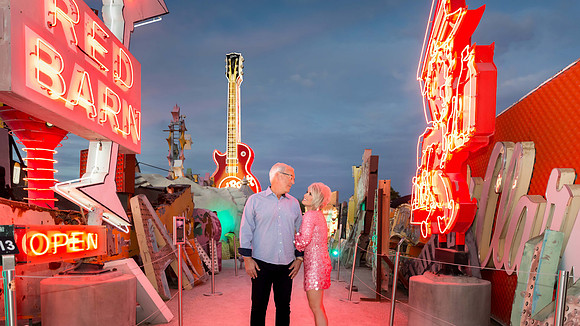 Couple photographed among vintage neon signs at the Neon Museum in Las Vegas