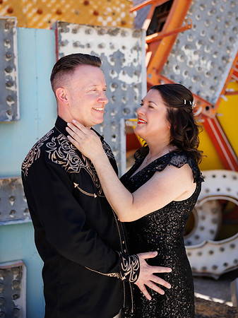 Couple photographed among vintage neon signs at the Neon Museum in Las Vegas