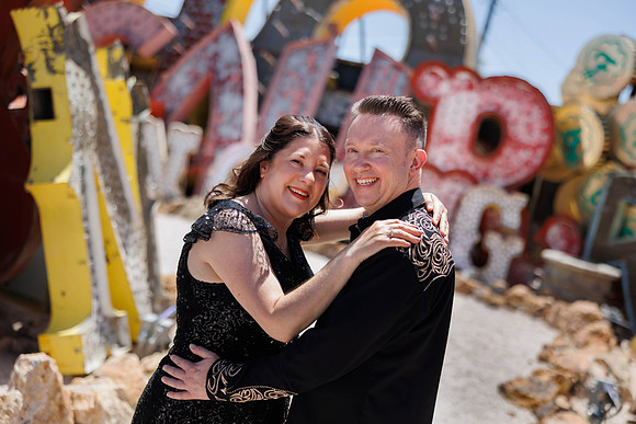Couple photographed among vintage neon signs at the Neon Museum in Las Vegas