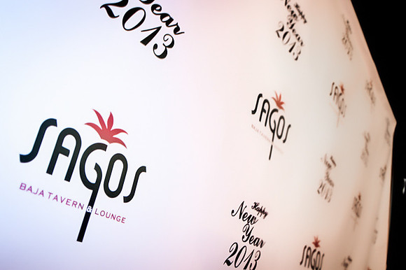 Guests posing on a red carpet in front of a step and repeat backdrop in Las Vegas