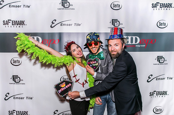 Guests posing on a red carpet in front of a step and repeat backdrop in Las Vegas