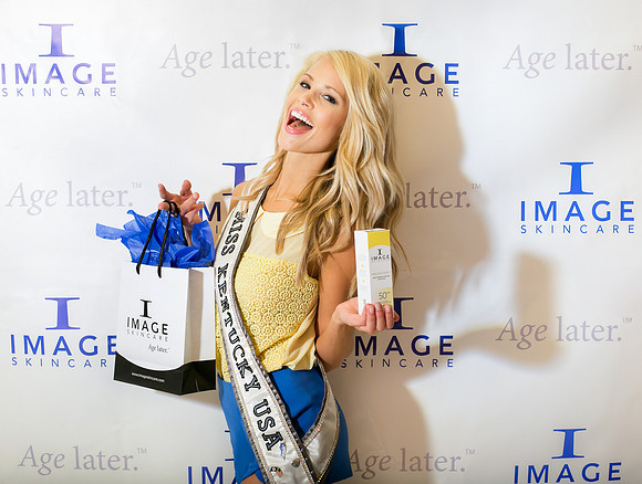 Guests posing on a red carpet in front of a step and repeat backdrop in Las Vegas