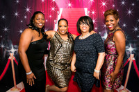 Guests posing on a red carpet in front of a step and repeat backdrop in Las Vegas