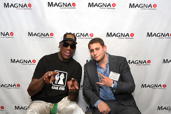 Guests posing on a red carpet in front of a step and repeat backdrop in Las Vegas