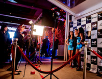 Guests posing on a red carpet in front of a step and repeat backdrop in Las Vegas