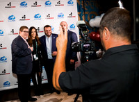 Guests posing on a red carpet in front of a step and repeat backdrop in Las Vegas
