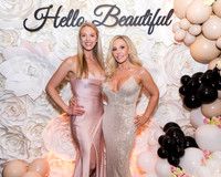 Guests posing on a red carpet in front of a step and repeat backdrop in Las Vegas