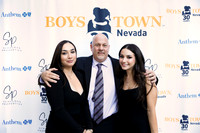 Guests posing on a red carpet in front of a step and repeat backdrop in Las Vegas