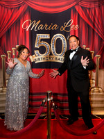 Guests posing on a red carpet in front of a step and repeat backdrop in Las Vegas