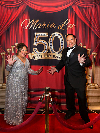 Guests posing on a red carpet in front of a step and repeat backdrop in Las Vegas