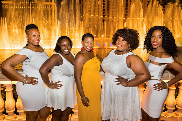 Friends posing together during a bachelorette photo shoot on the Las Vegas Strip