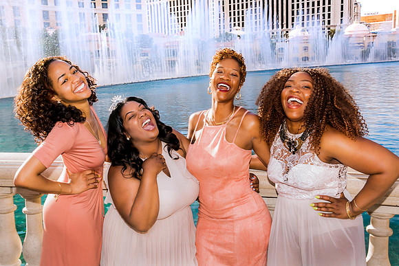 Friends posing together during a bachelorette photo shoot on the Las Vegas Strip