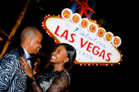 Couple embracing during an anniversary photo shoot at the Welcome to Fabulous Las Vegas Sign.
