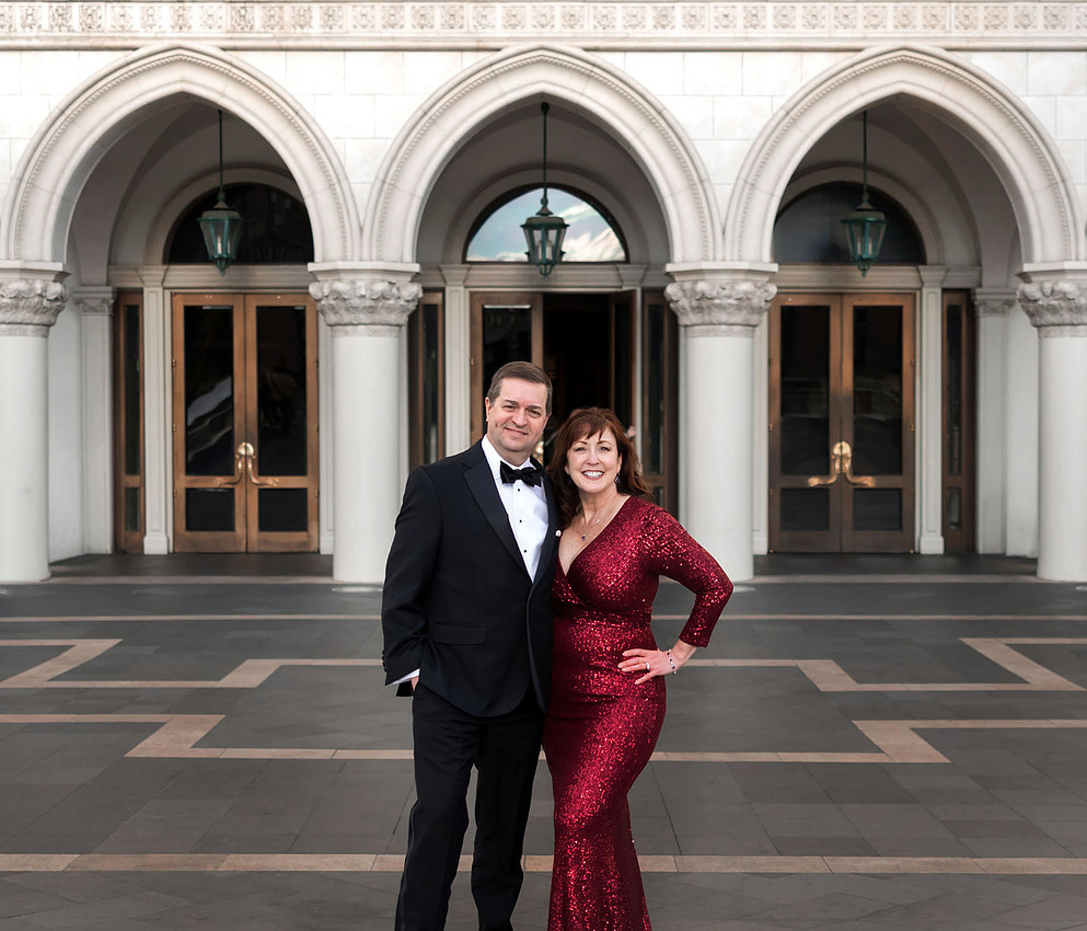 Couple dressed formally outside The Venetian during a Las Vegas anniversary photography session.