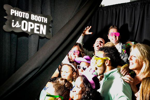 Guests posing in a photo booth with props at a Las Vegas event