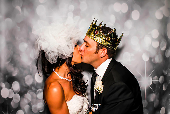 Guests posing in a photo booth with props at a Las Vegas event