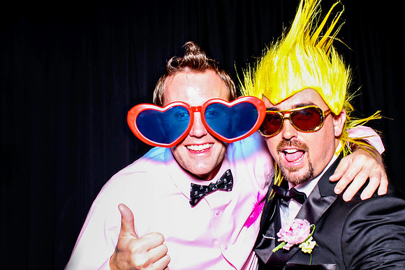 Guests posing in a photo booth with props at a Las Vegas event