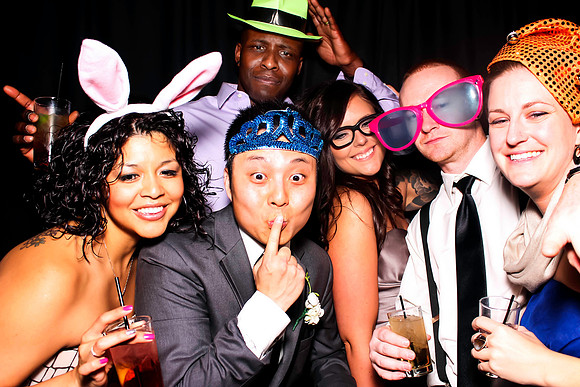 Guests posing in a photo booth with props at a Las Vegas event