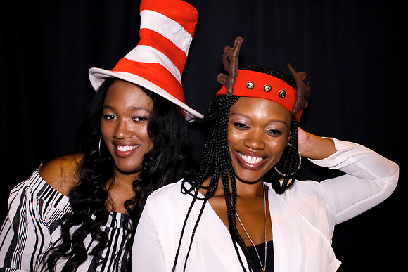 Guests posing in a photo booth with props at a Las Vegas event