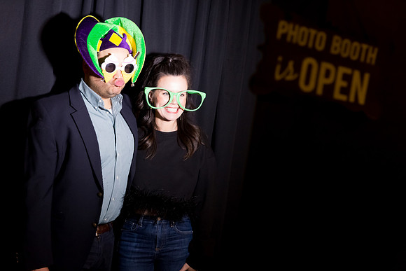 Guests posing in a photo booth with props at a Las Vegas event