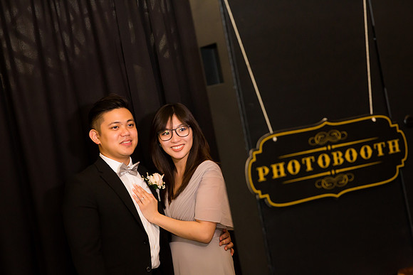 Guests posing in a photo booth with props at a Las Vegas event