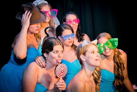 Guests posing in a photo booth with props at a Las Vegas event